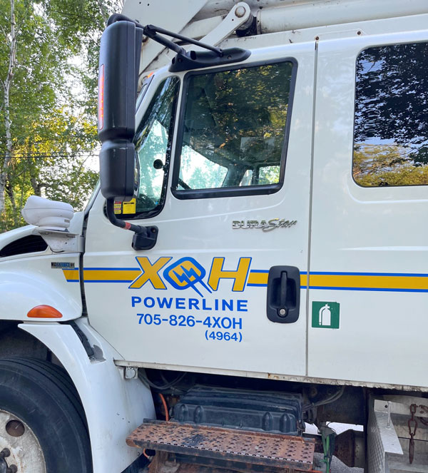 Close up of the XOH Powerline logo on a service truck.