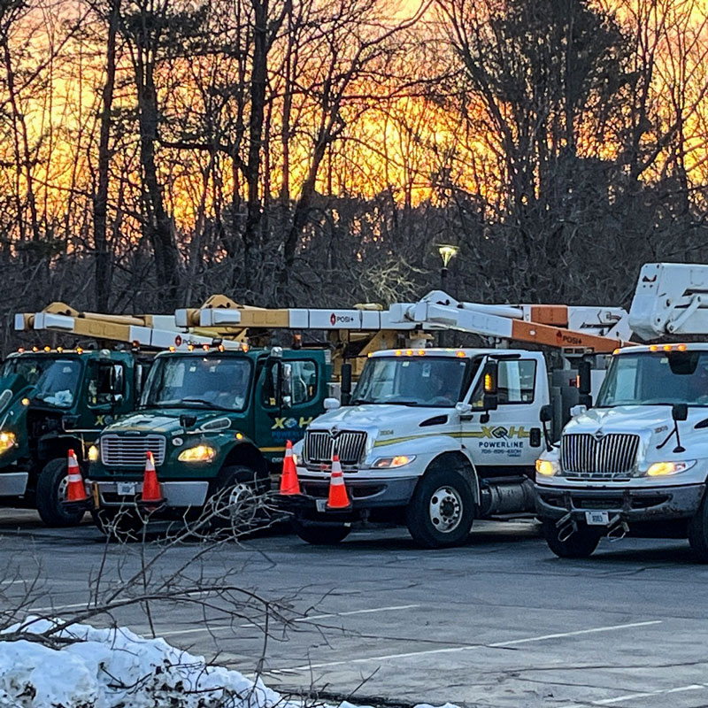 XOH trucks in a line getting ready to go out to a storm site.